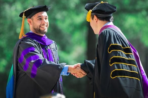 A Regent University graduate being congratulated during Commencement,