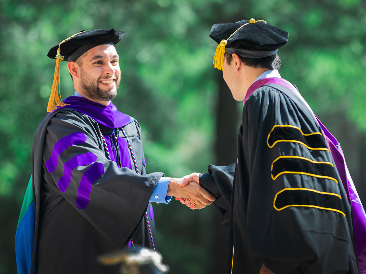 A Regent University graduate being congratulated during Commencement,