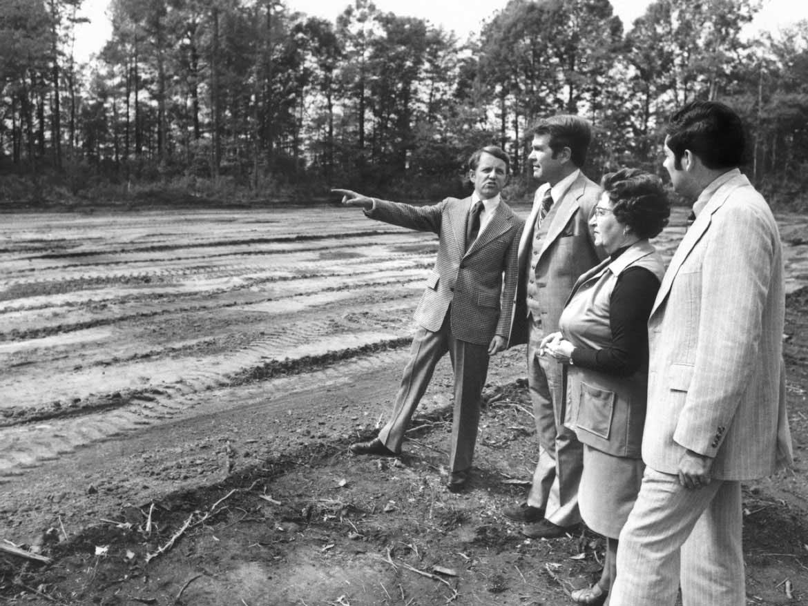 Archive photo of Dr. M.G. “Pat” Robertson and staff viewing site of future Regent University.