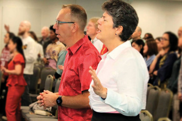 A photo of Jacob and Linda Bloemberg worship God at a church service: Learn more about Regent Giving opportunities.
